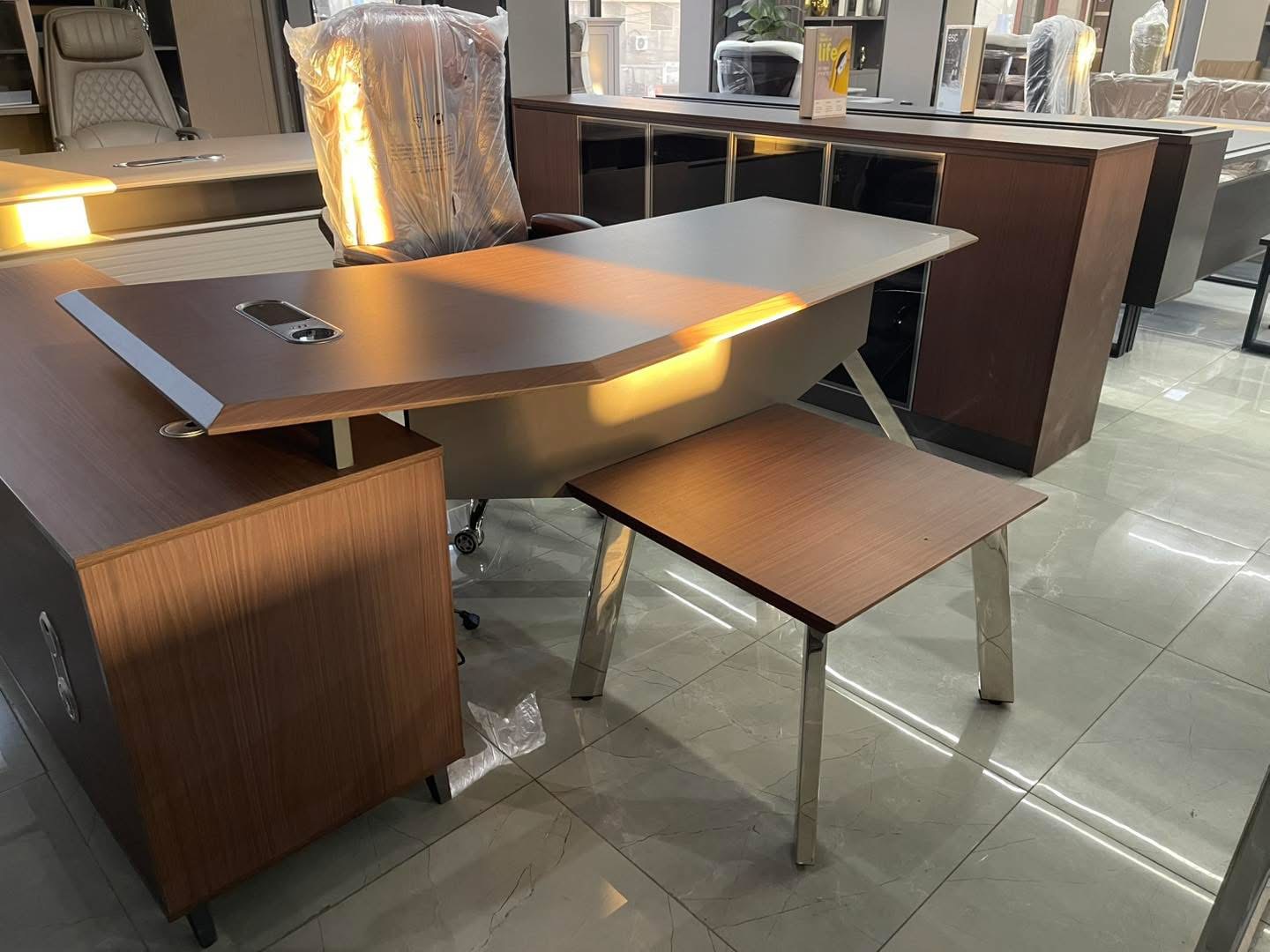 Customer office furniture showroom executive desk and storage display used as direct contact reference