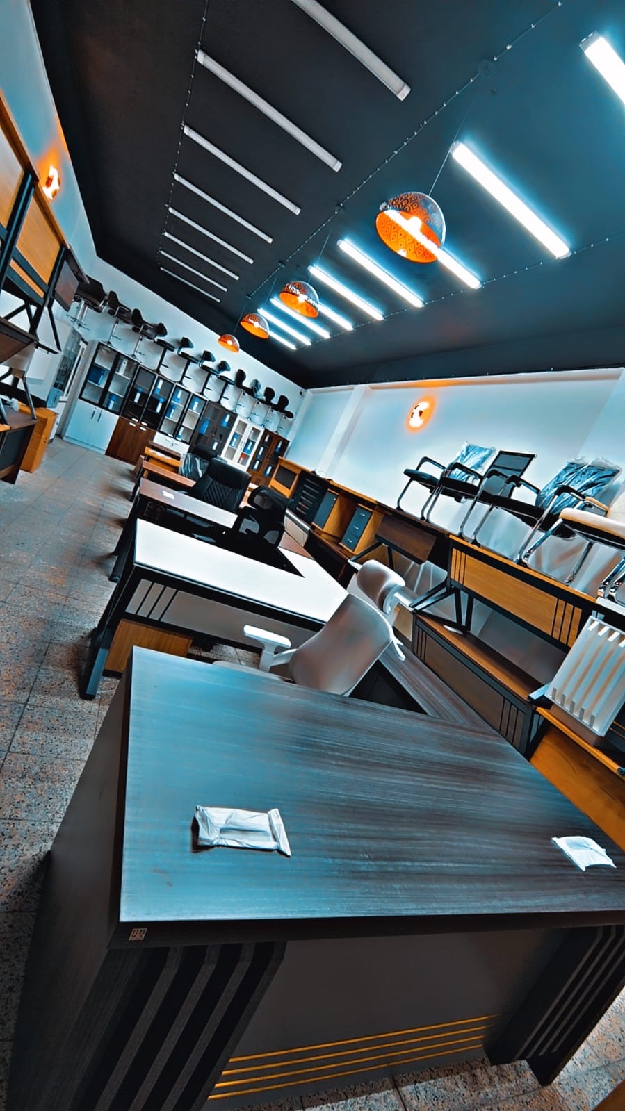 Kyrgyzstan buyer showroom-floor reference with office desks, storage and display mix